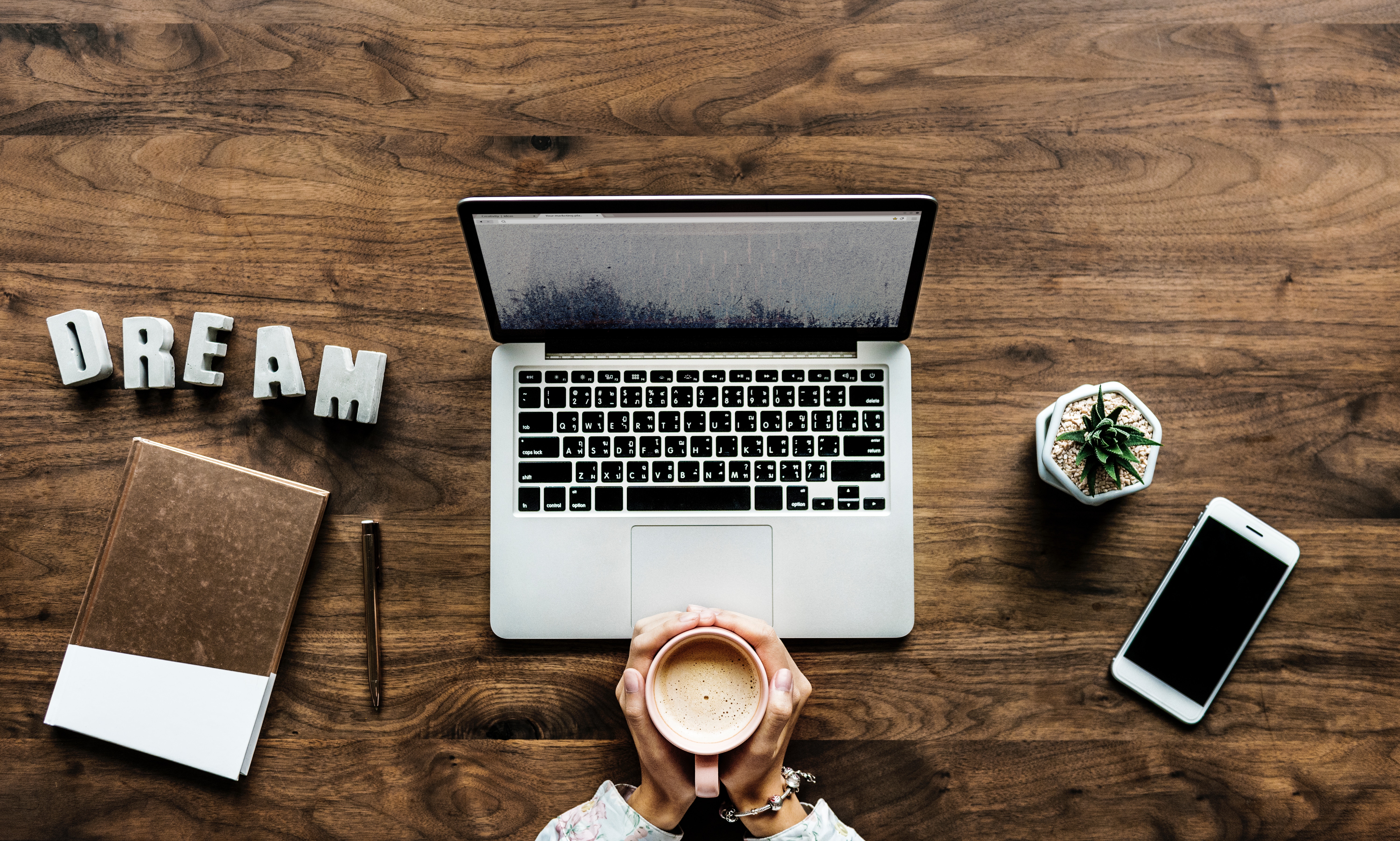 Table from top with computer, dream and cup of coffee